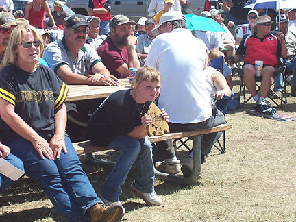 2005 Bowhunters Weekend Young shooter looks on
                    with her award